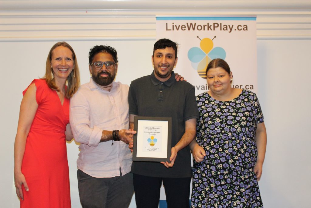 Joe Thottungal and team accepting the award from Anna Nelson